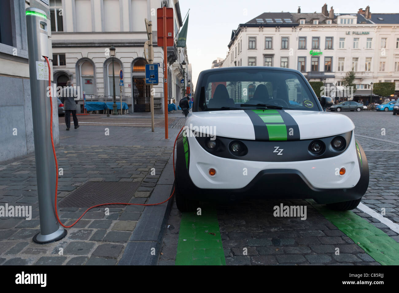 An electric car, designed in Europe, charging by a charging station