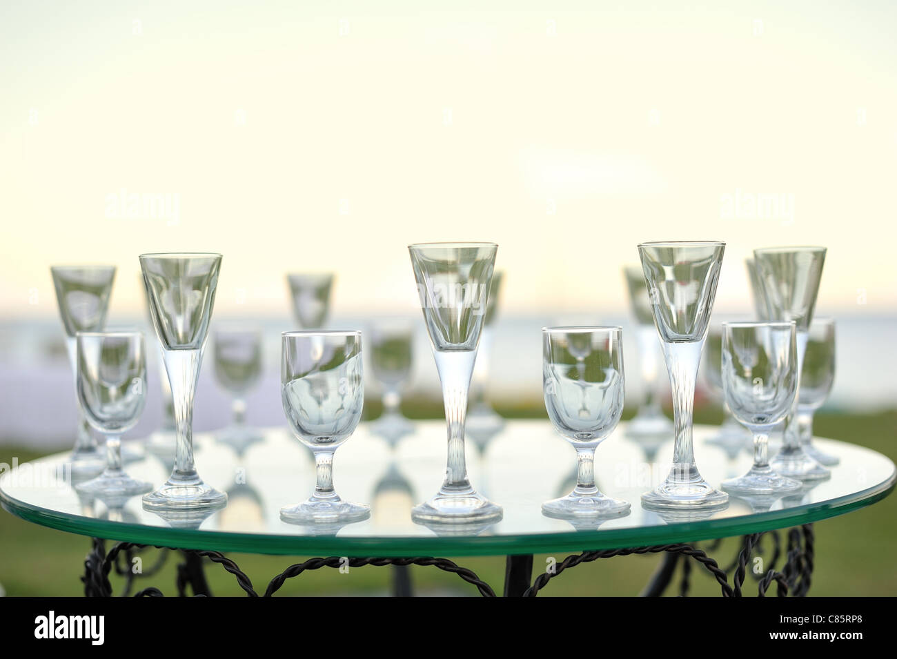 Laying of glasses on a glass table of the different sizes Stock Photo