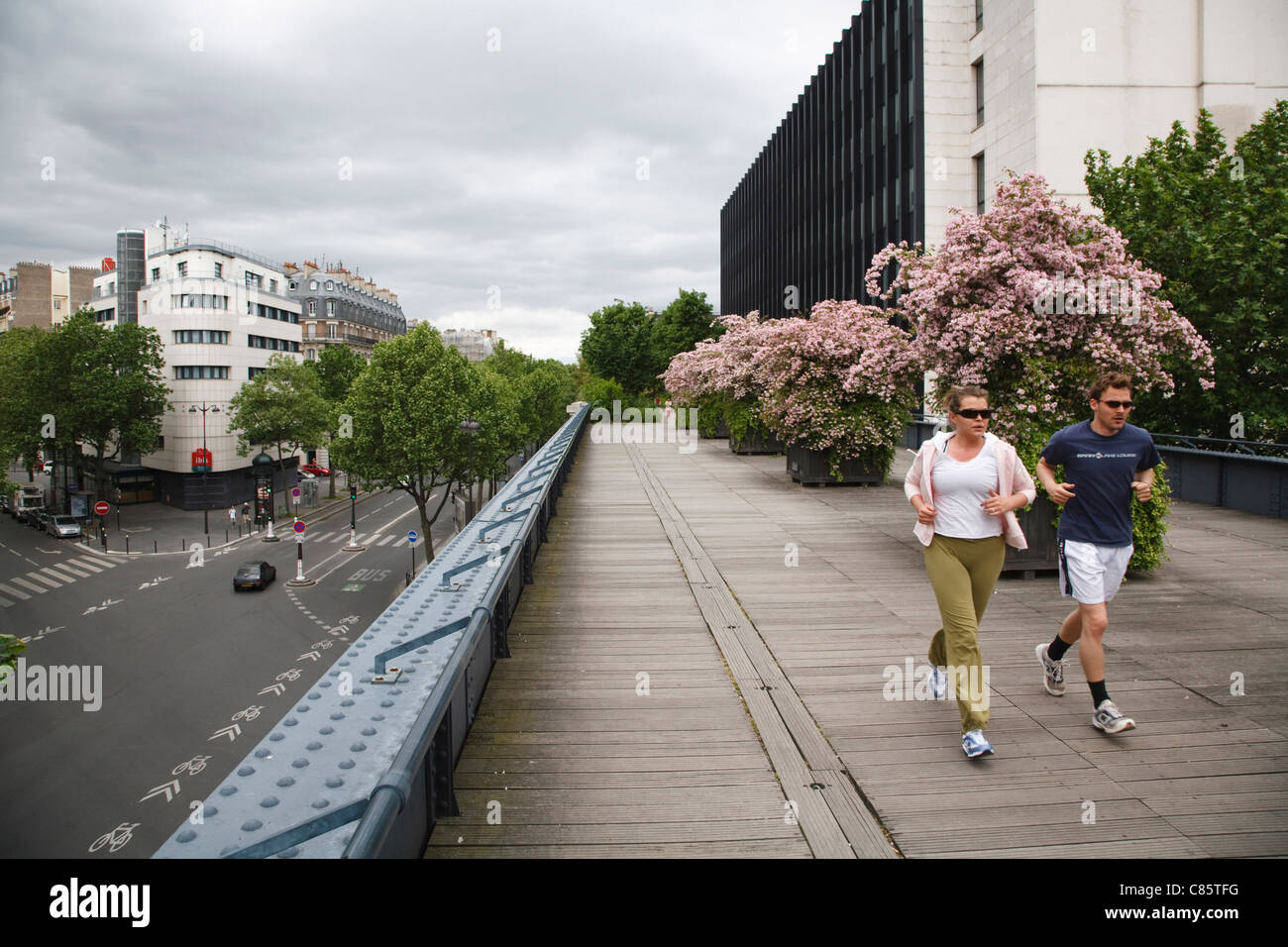 Joggers run along La Promenade Plantee, a garden on top of Le Viaduc des Arts, France Stock Photo