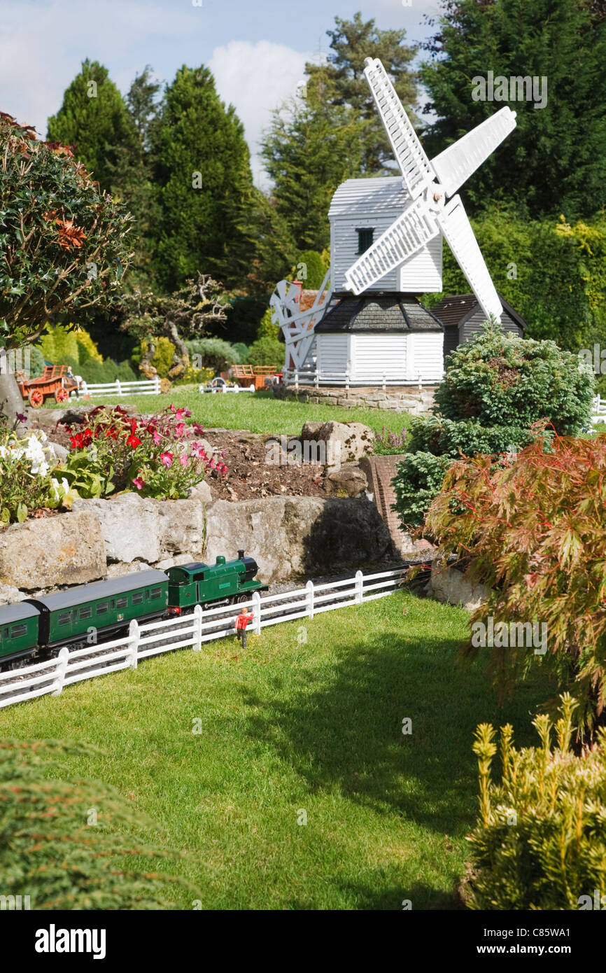 Train and windmill at Bekonscot model village and railway, Beaconsfield, Buckinghamshire, UK Stock Photo