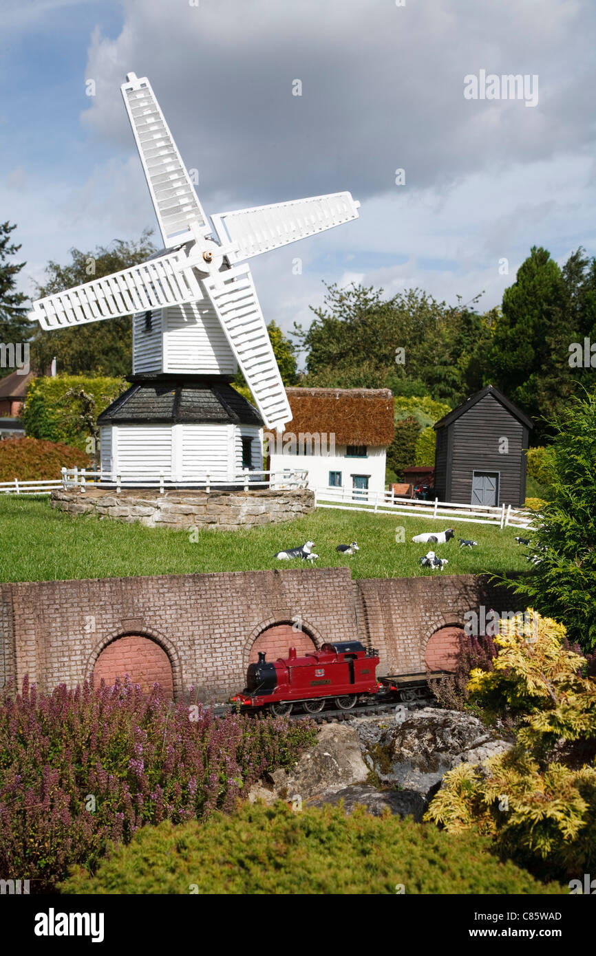 Train and windmill at Bekonscot model village and railway, Beaconsfield, Buckinghamshire, UK Stock Photo