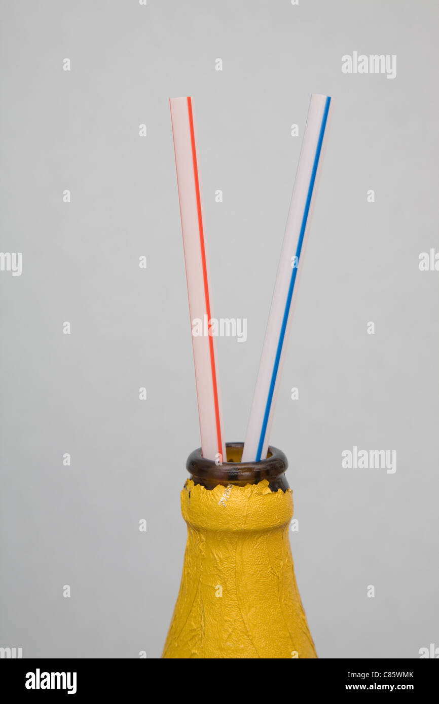 Two drinking straws in a beer bottle Stock Photo Alamy