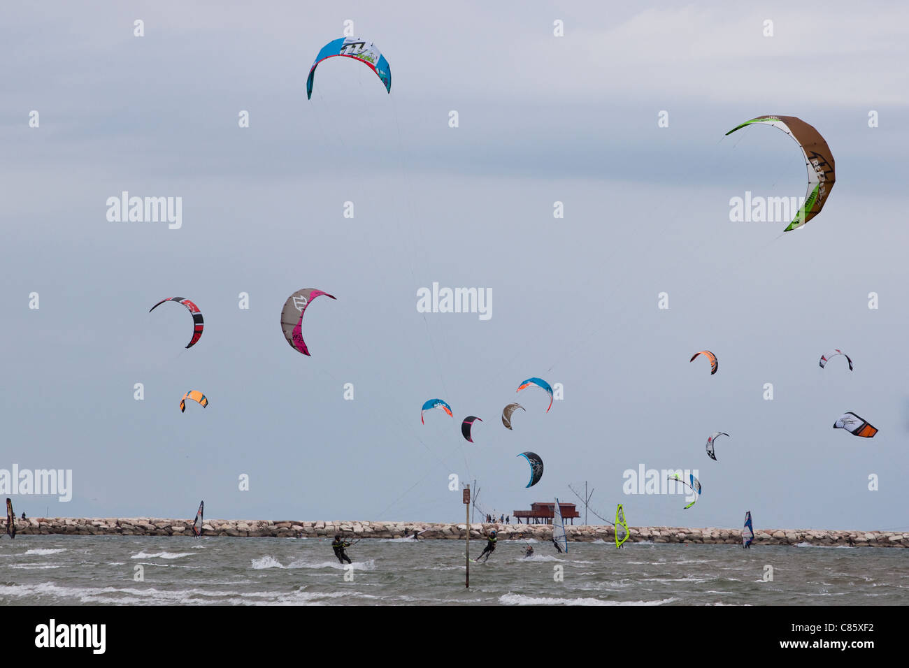 Kitesurfs in Sottomarina during a windy day Stock Photo