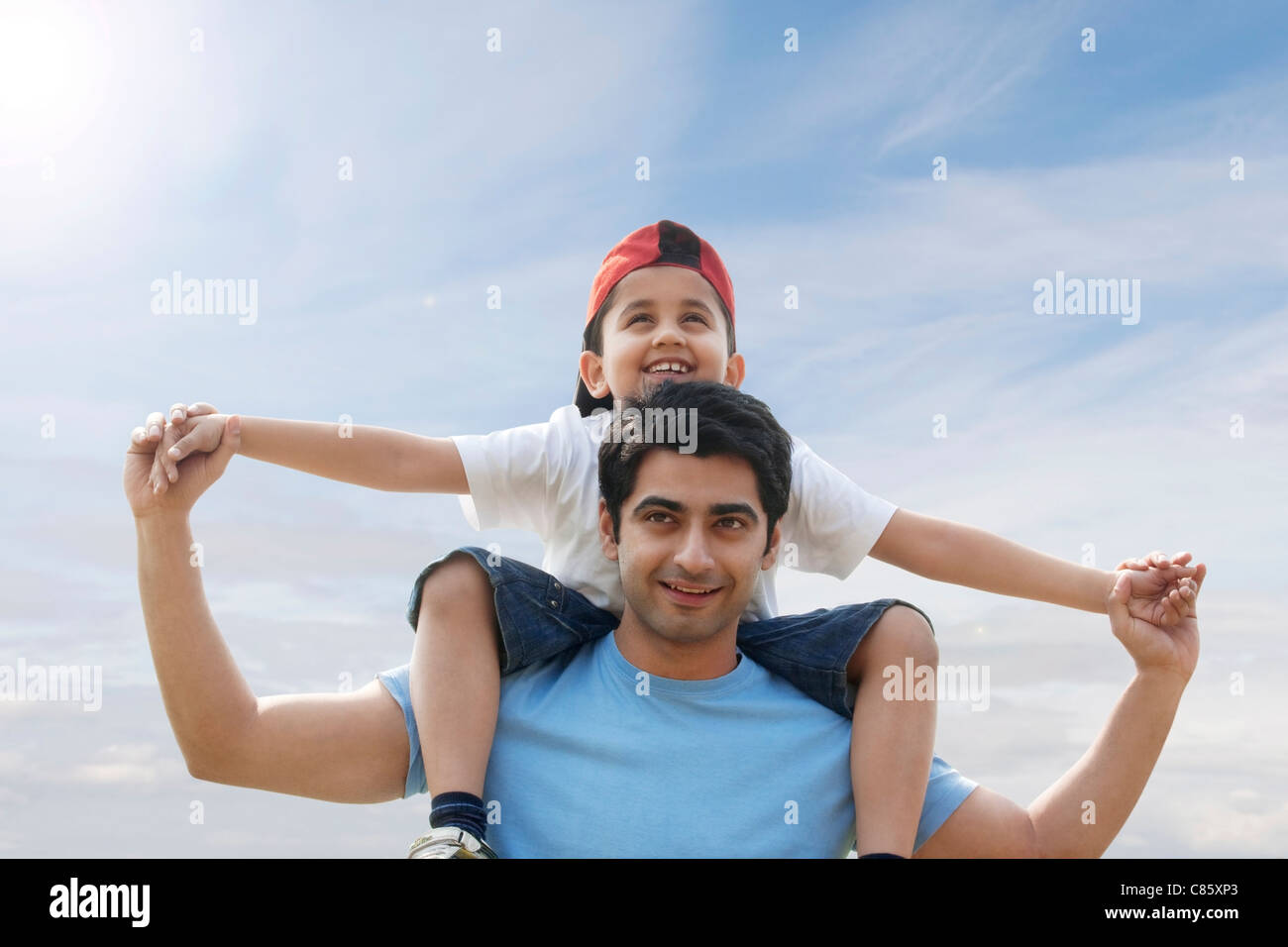 Son getting a piggyback ride from his father Stock Photo