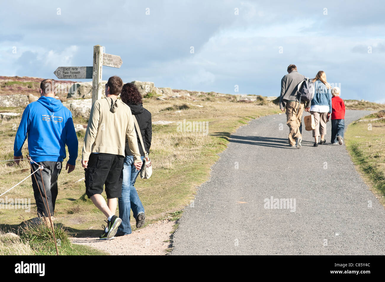 August 2011  -Lands End, Cornwall, UK - Walkers on wild landscape Stock Photo