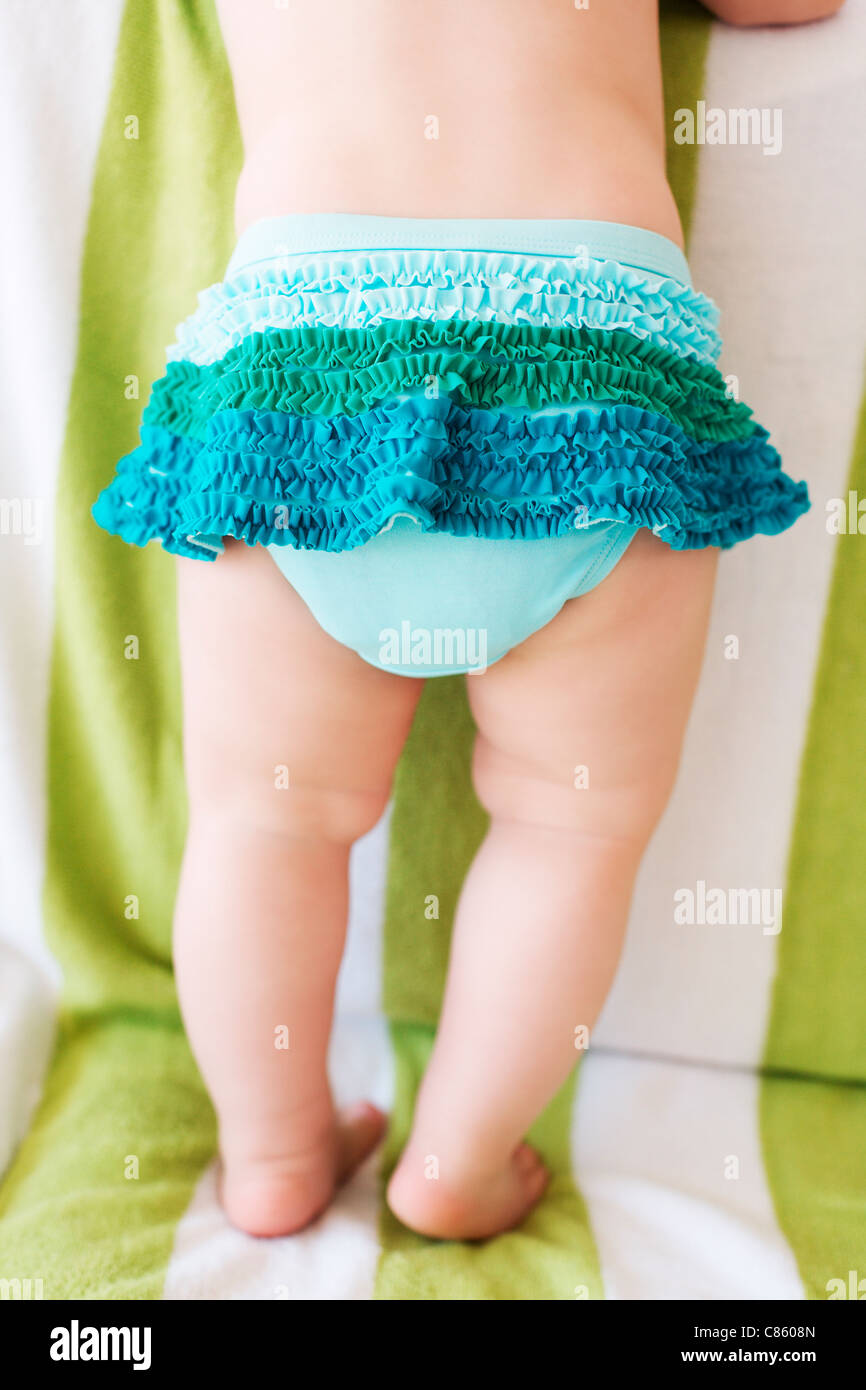Little baby wearing a ruffled blue skirt Stock Photo