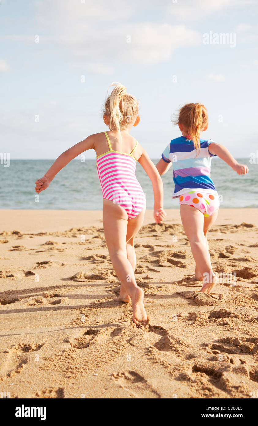 Little girls running on beach Stock 