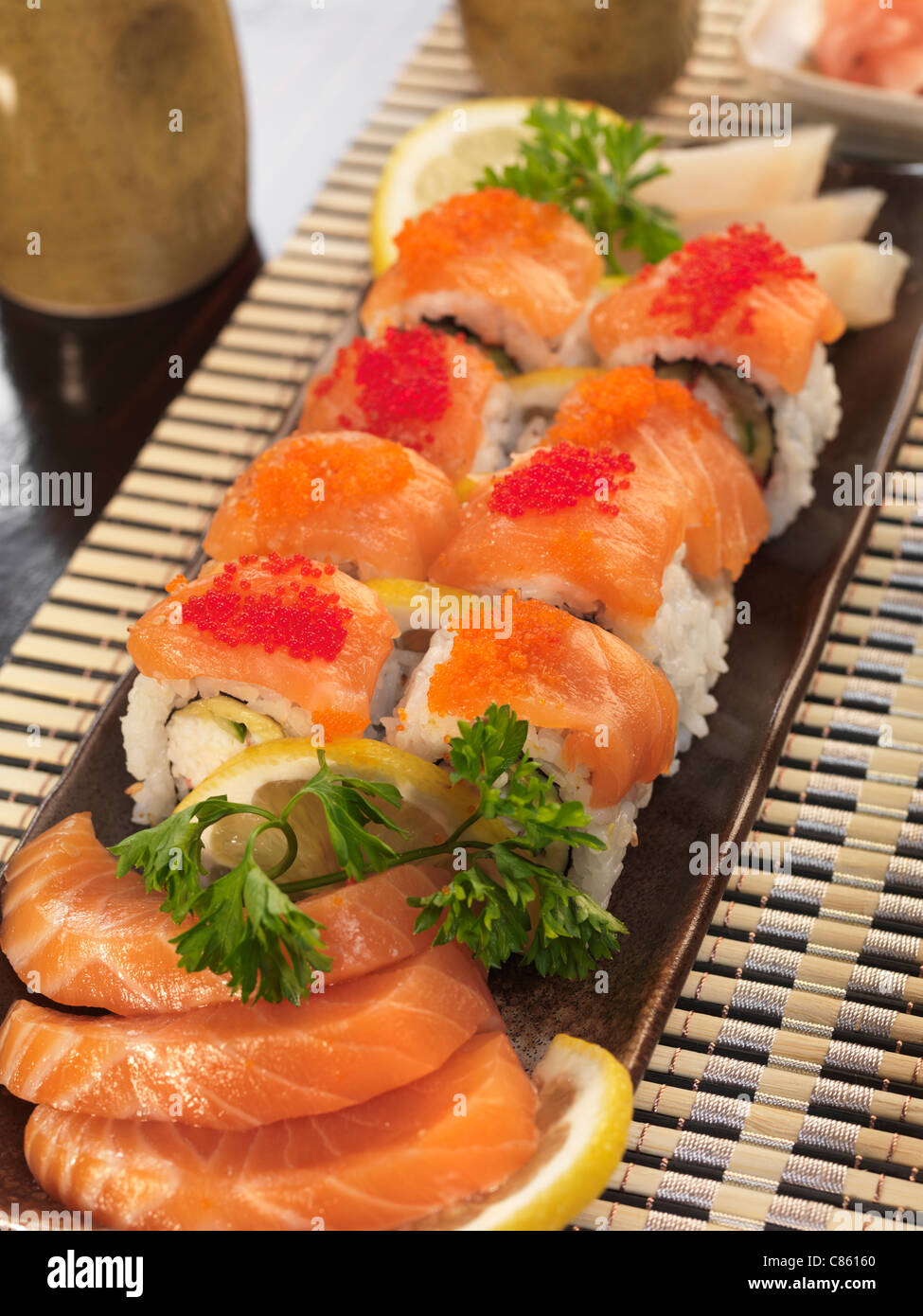 Served sushi rolls and sashimi Stock Photo