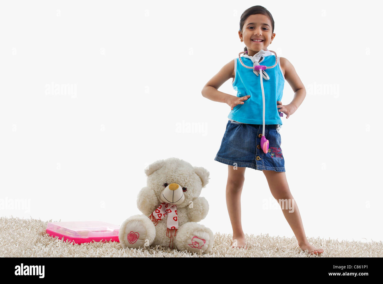 Young girl standing next to her teddy bear Stock Photo - Alamy