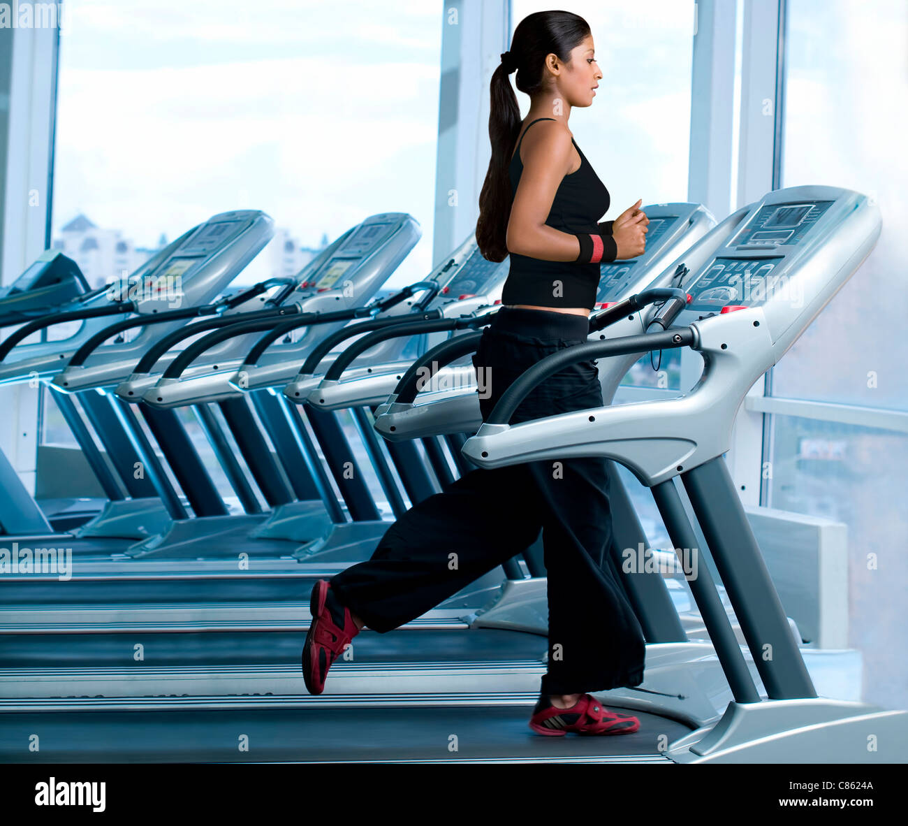 Woman running on a treadmill in a gym Stock Photo Alamy