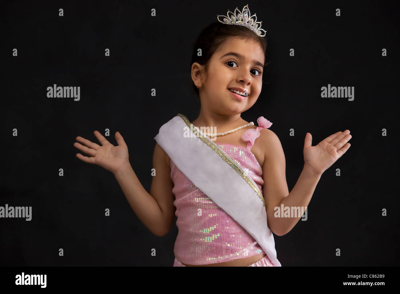 Standing looking at camera smiling tiara sash beauty queen hires stock