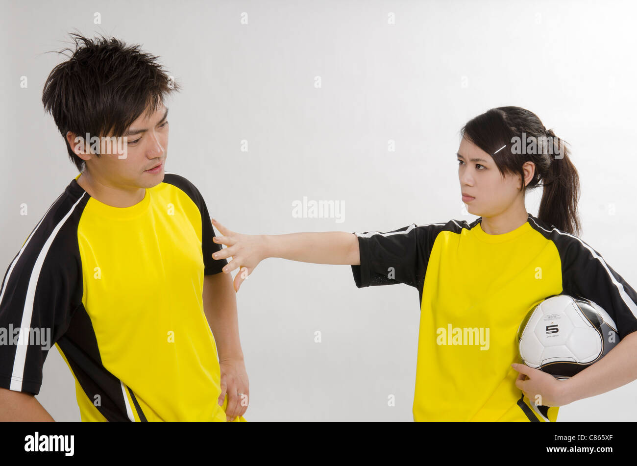 young couple as football players Stock Photo