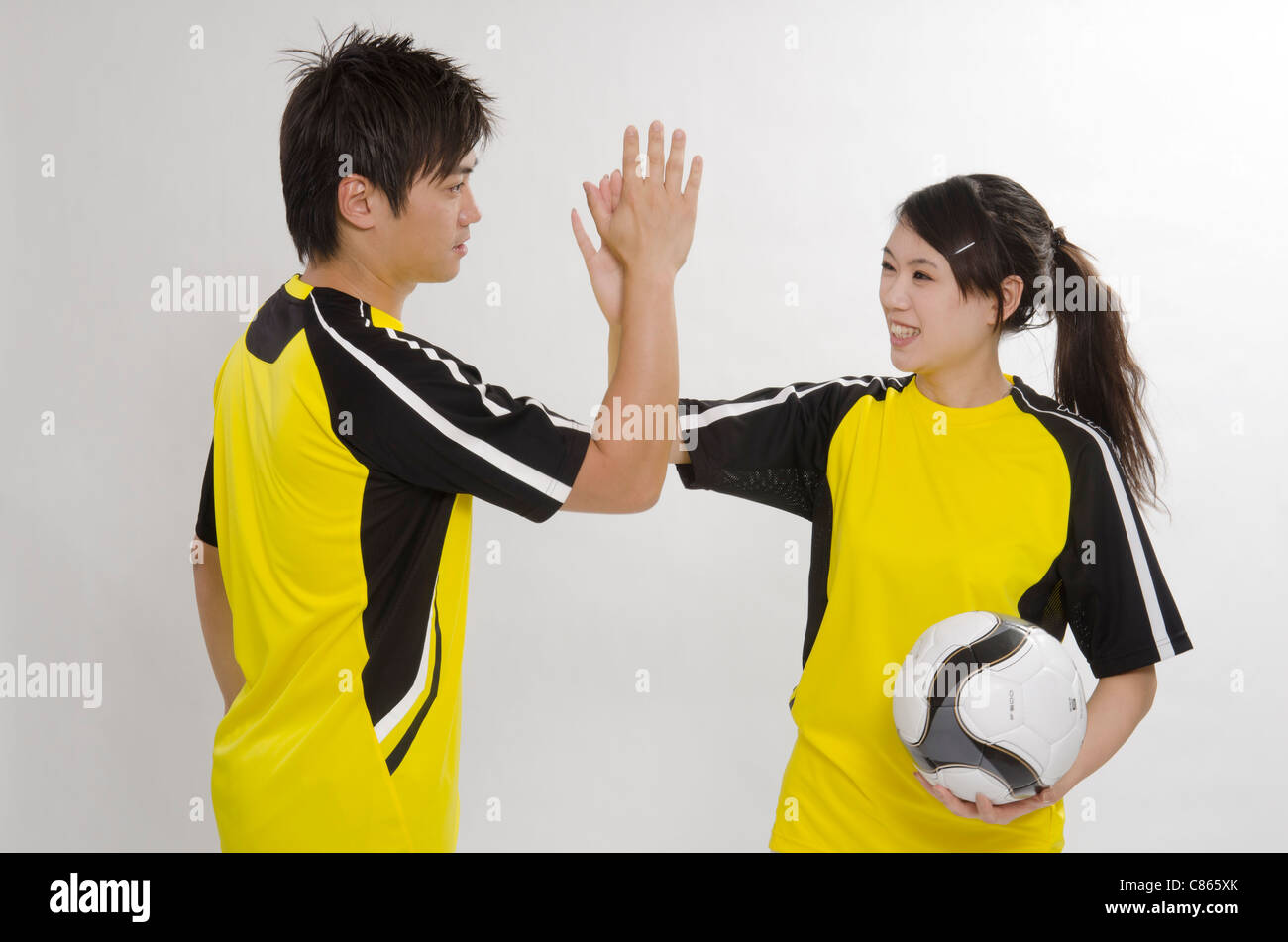 young couple as football players Stock Photo
