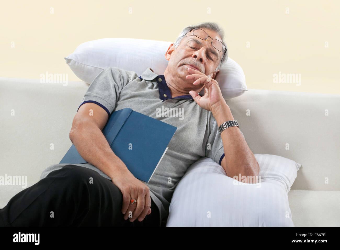 Old man taking a nap on a sofa Stock Photo Alamy