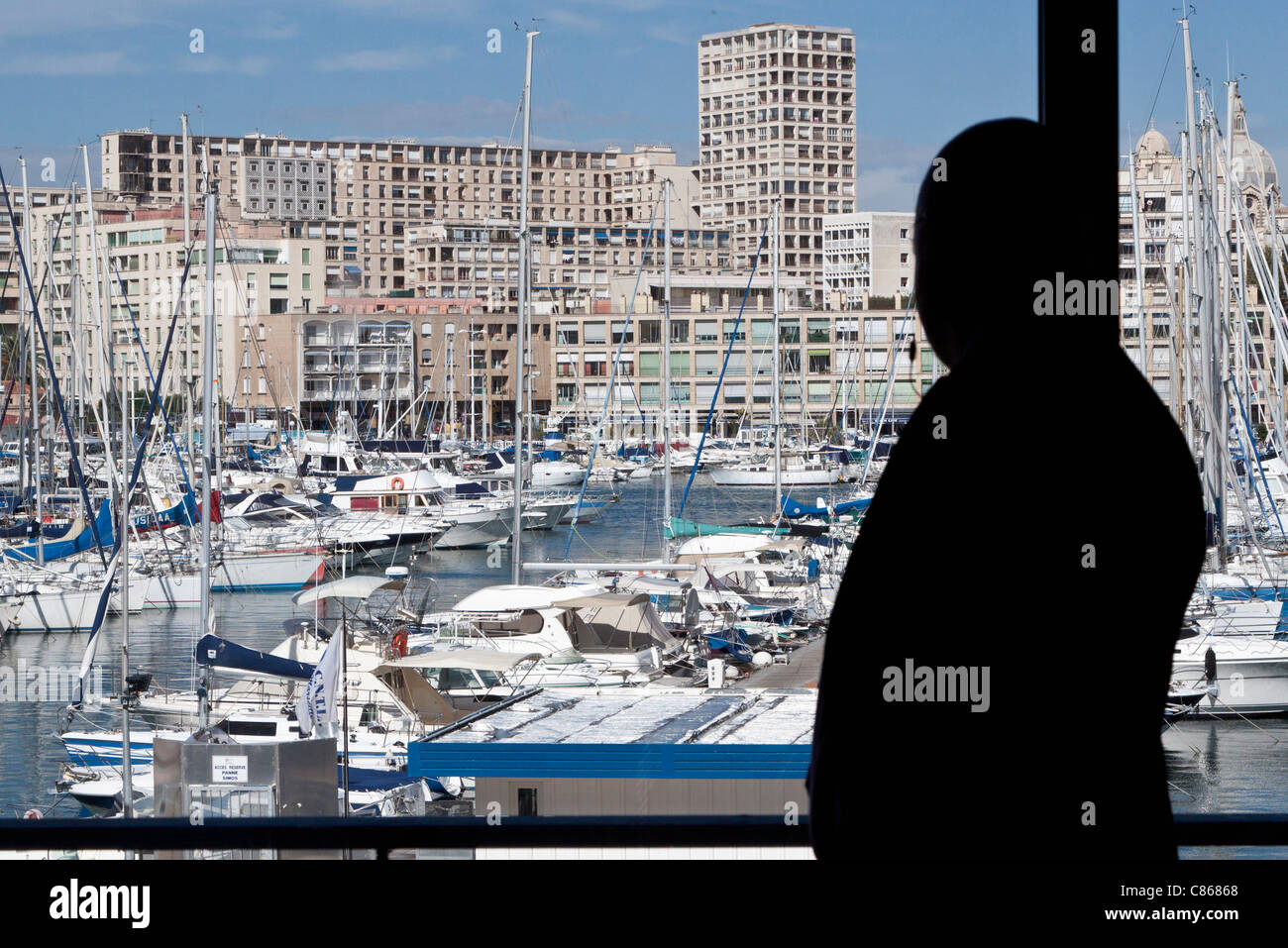 Silhouette of person looking at view of harbor Stock Photo