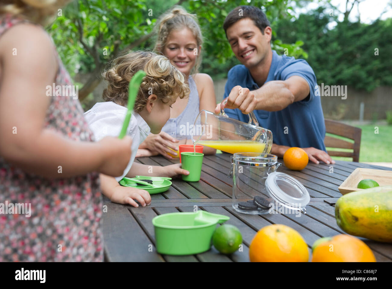 Family enjoying outdoor snack Stock Photo Alamy