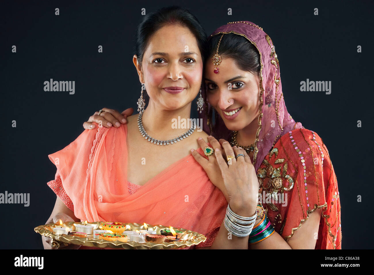 Mother and daughter with a tray of diyas Stock Photo