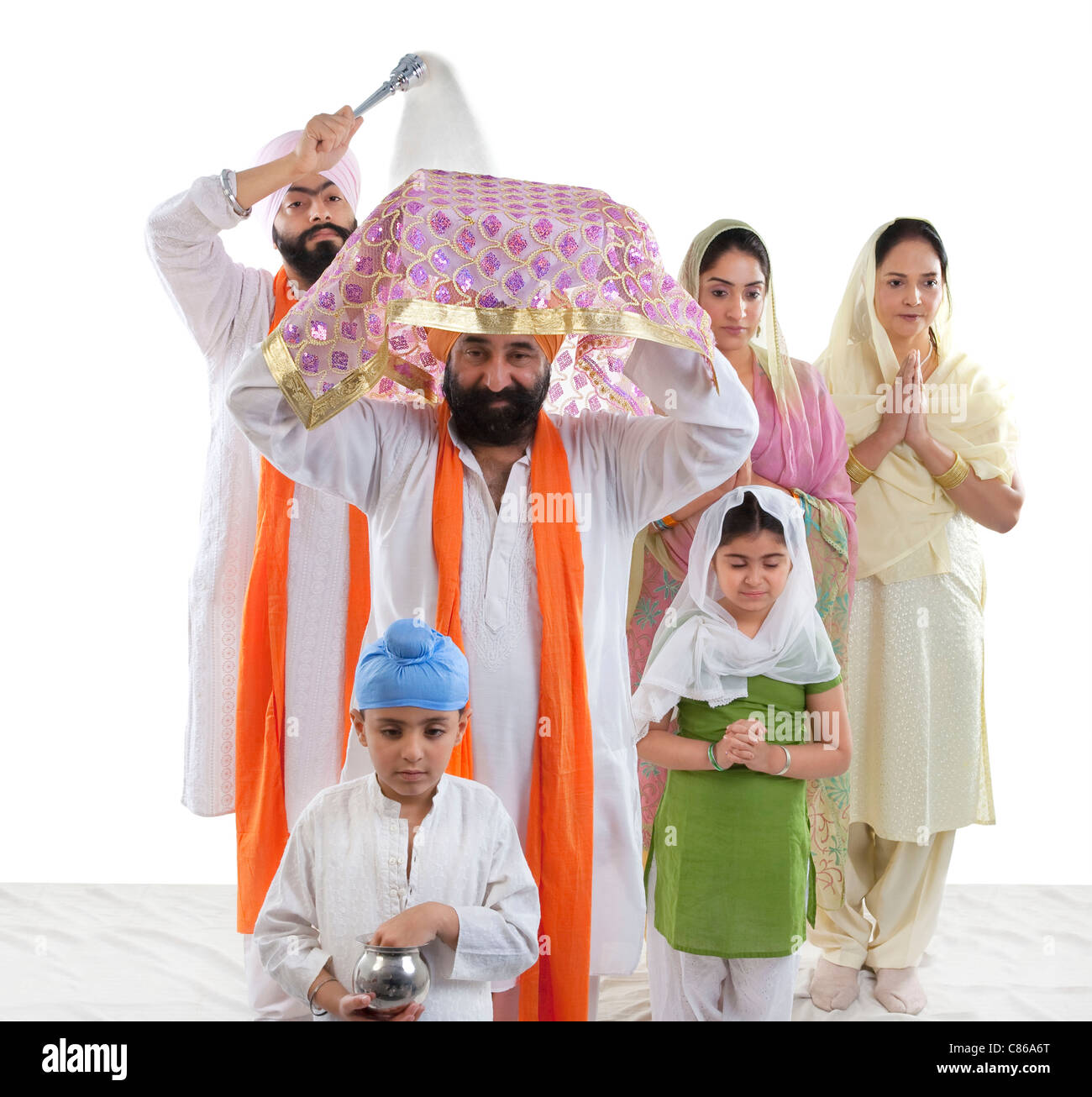 Sikh family performing a ritual ceremony Stock Photo