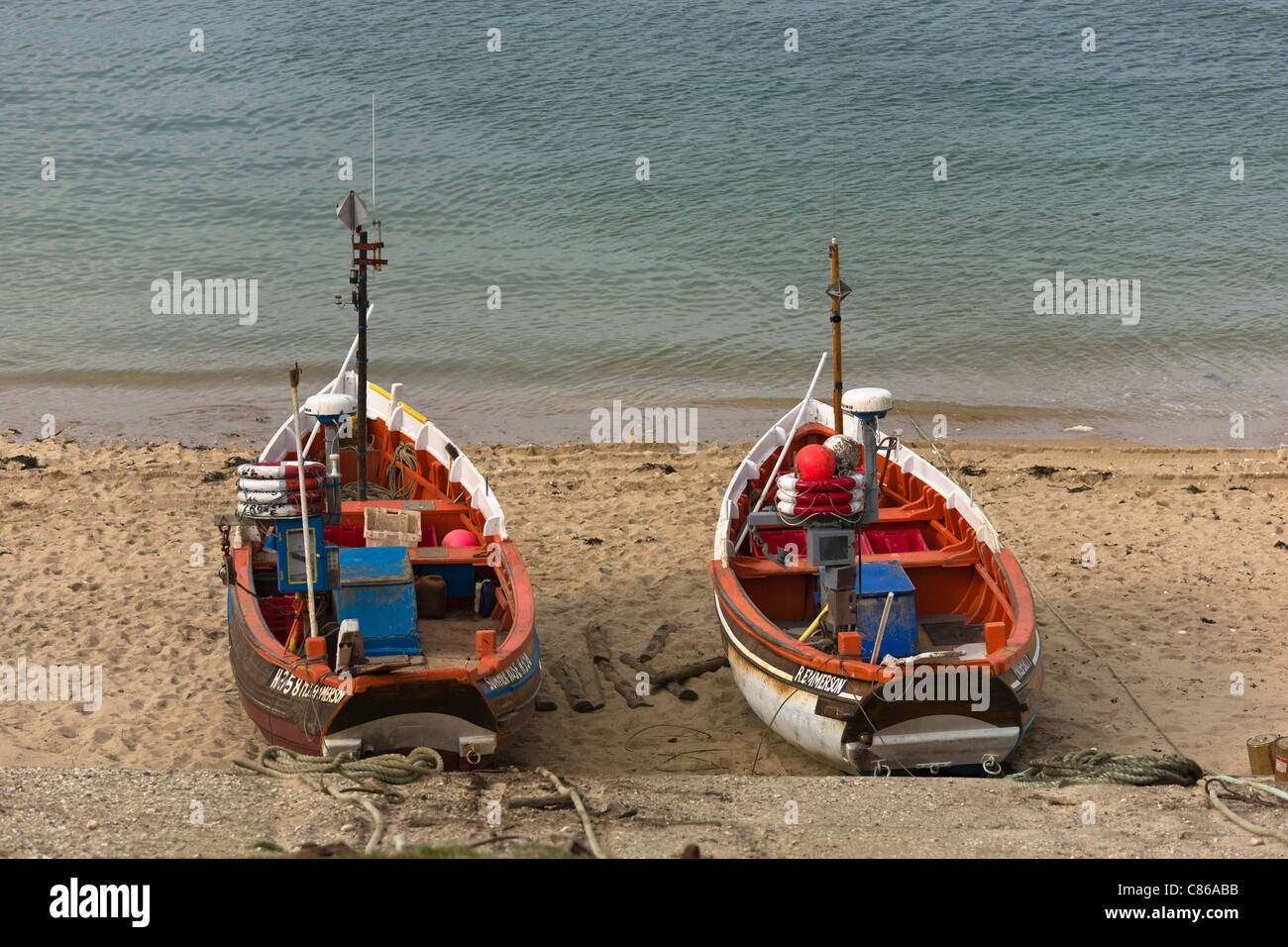 Two beached fishing boats hi-res stock photography and images - Alamy
