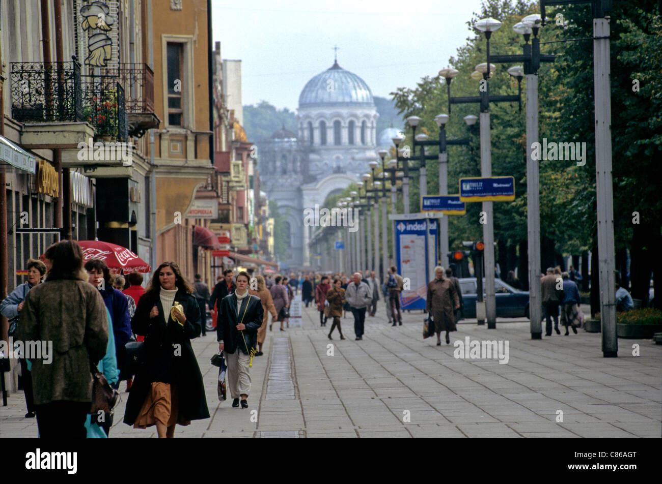 Kaunas, Lithuania. People walking on the street with row of lampposts, the Russian Orthodox Church in the centre. Stock Photo