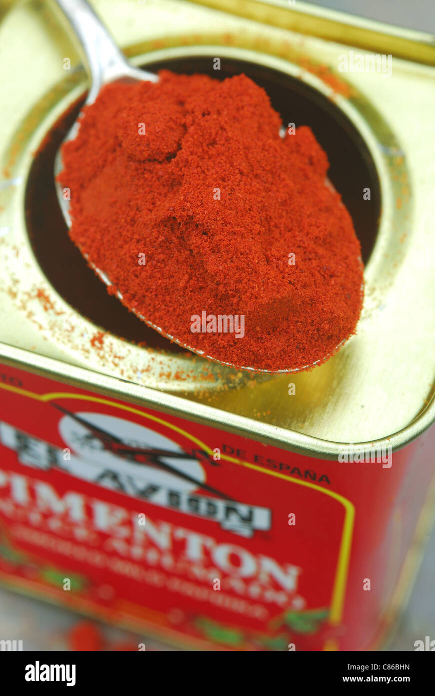 A spoon and tin of Spanish smoked mild paprika powder (pimenton dulce