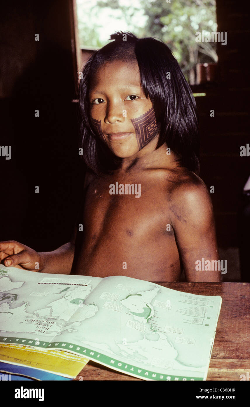 A-ukre village, Brazil. Pidjuri, a Kayapo boy, studying geography in the school; Xingu Indigenous Area, Para state. Stock Photo
