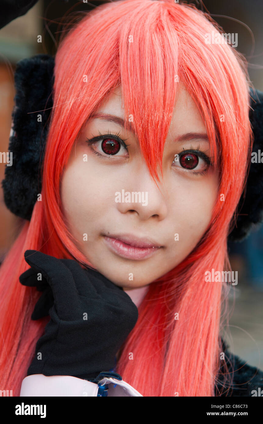 red haired Thai girl with big eyes posing at the Cosplay Festival in Bangkok Stock Photo