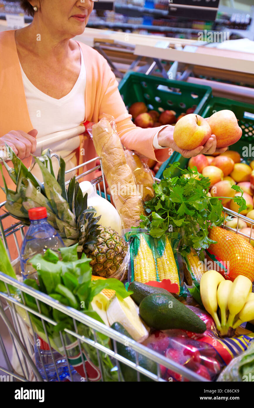 Image of senior woman with fresh vegetables and fruits in cart Stock ...