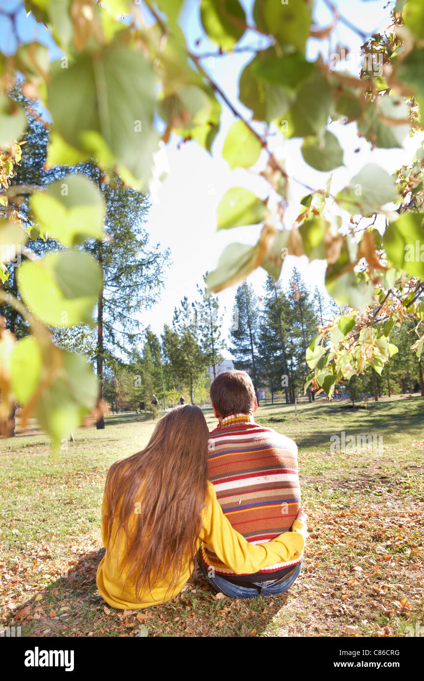 Rear view of affectionate couple relaxing outdoors in autumn Stock ...