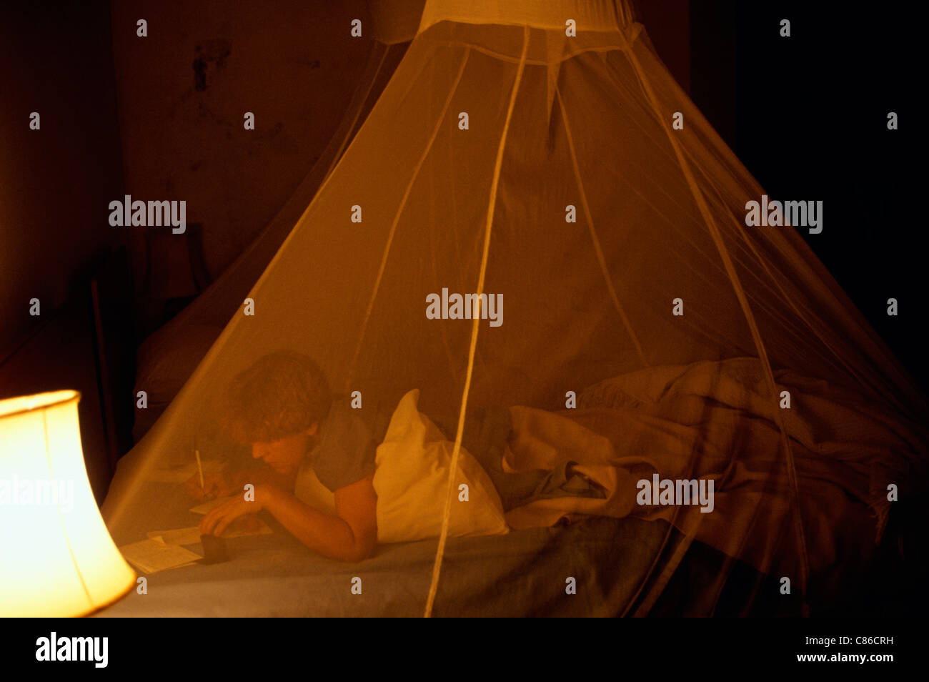 Zambia. Tourist on safari sleeping under a mosquito net Stock Photo Alamy