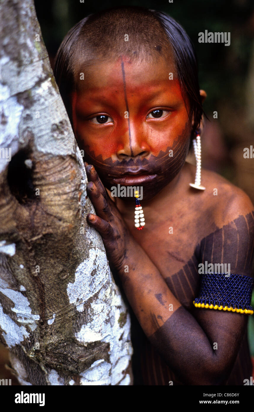 A-Ukre Village, Brazil. Young Kayapo boy with red urucum and black genipapo face paint and bead lip decoration. Para State. Stock Photo