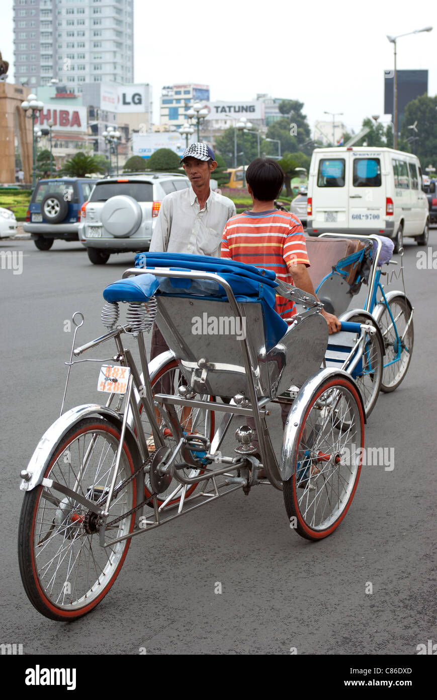 Vietnamese Cyclo drivers waiting for tourists near Ben Thanh Market, Saigon Vietnam Stock Photo