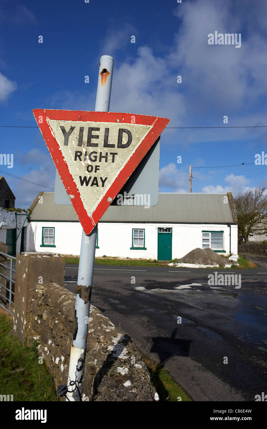 old irish red triangle yield right of way sign in rural ireland Stock Photo