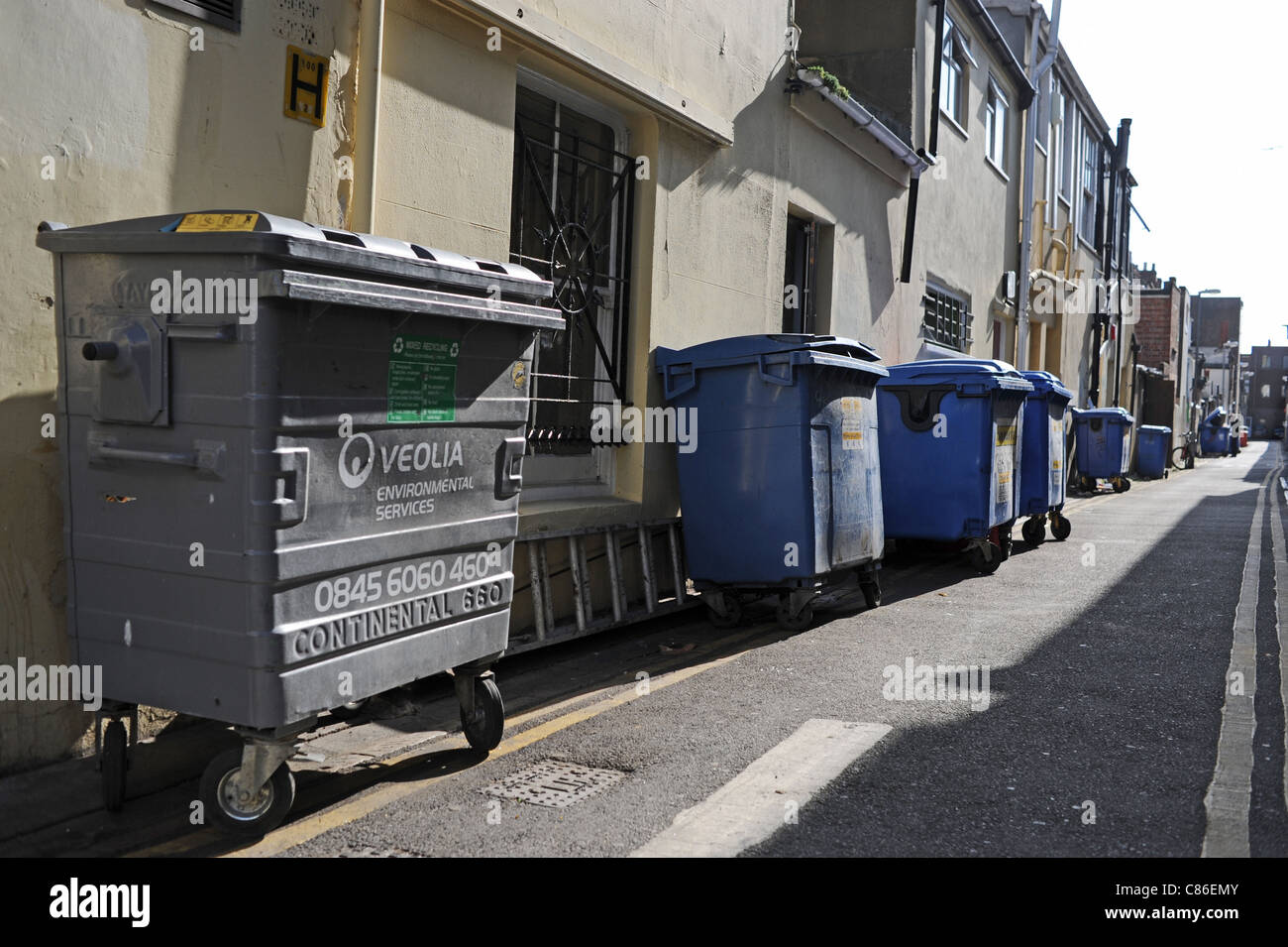 Veolia environmental services wheelie bins for rubbish down a narrow