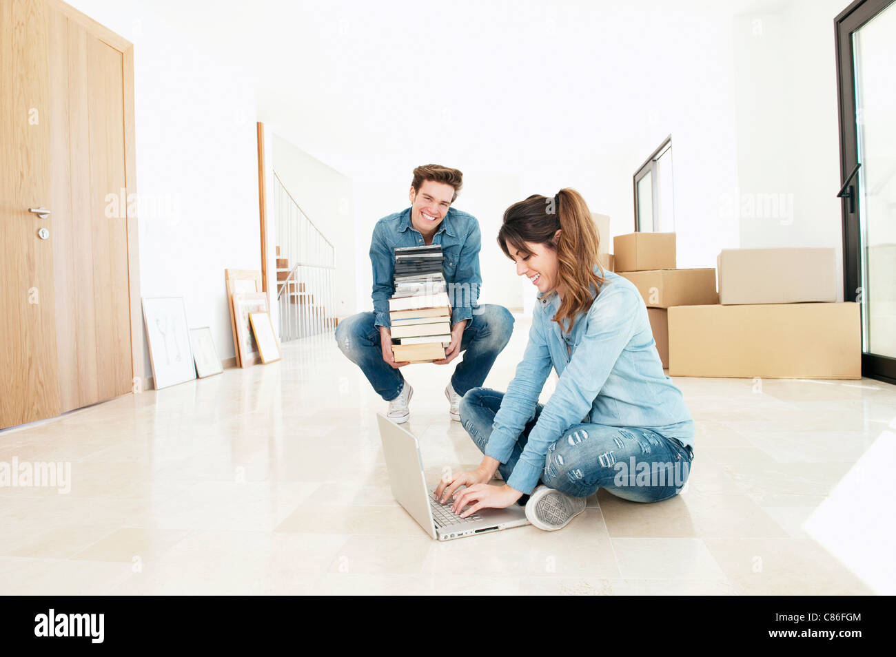 Couple moving into new home Stock Photo