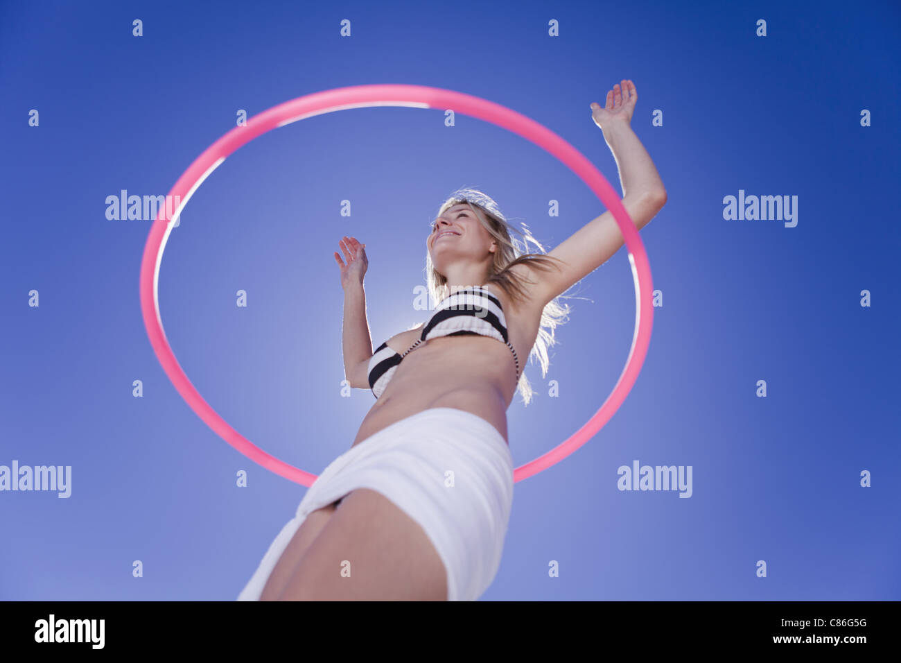 Low angle view of woman hula hooping Stock Photo