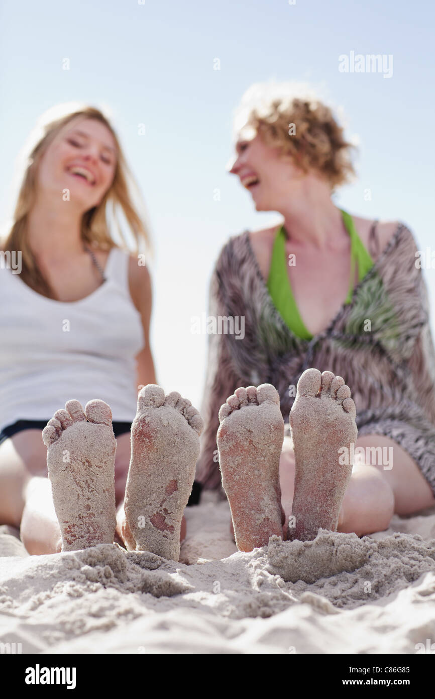 Close up of women’s sandy feet on beach Stock Photo
