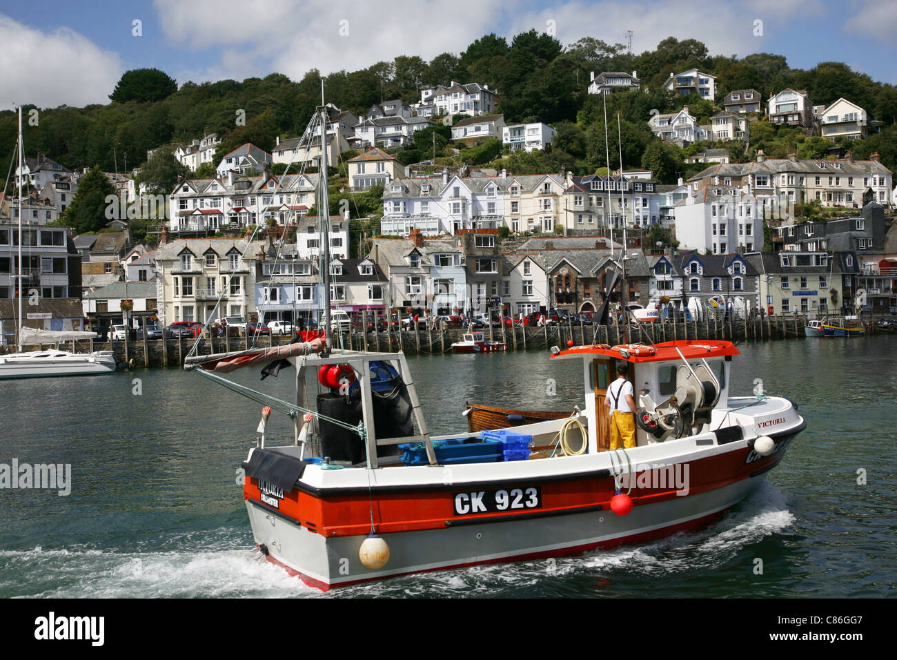 Fishing boat returning to the port of Looe a popular resort of Looe on ...