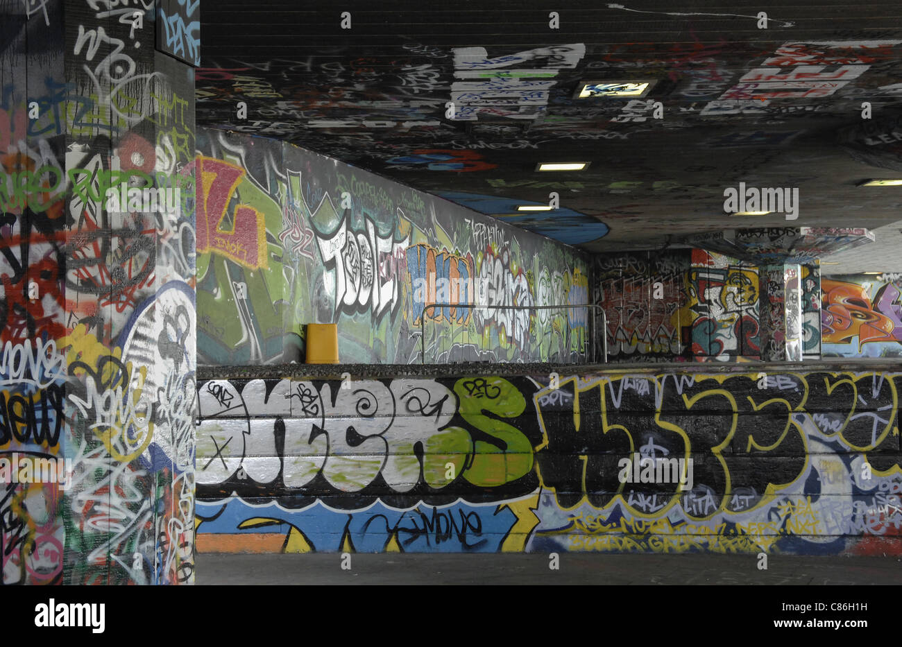 Graffiti and street art in area designated for skateboarders and BMX riders. South Bank of River Thames near Waterloo in London. Stock Photo
