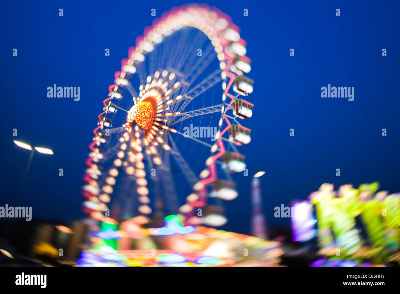 Ferris wheel lit up against night sky Stock Photo