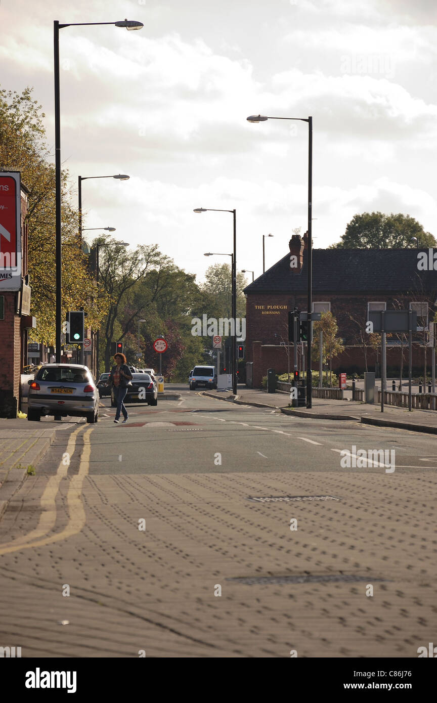 Road with parked cars and pedestrian crossing the road Stock Photo - Alamy
