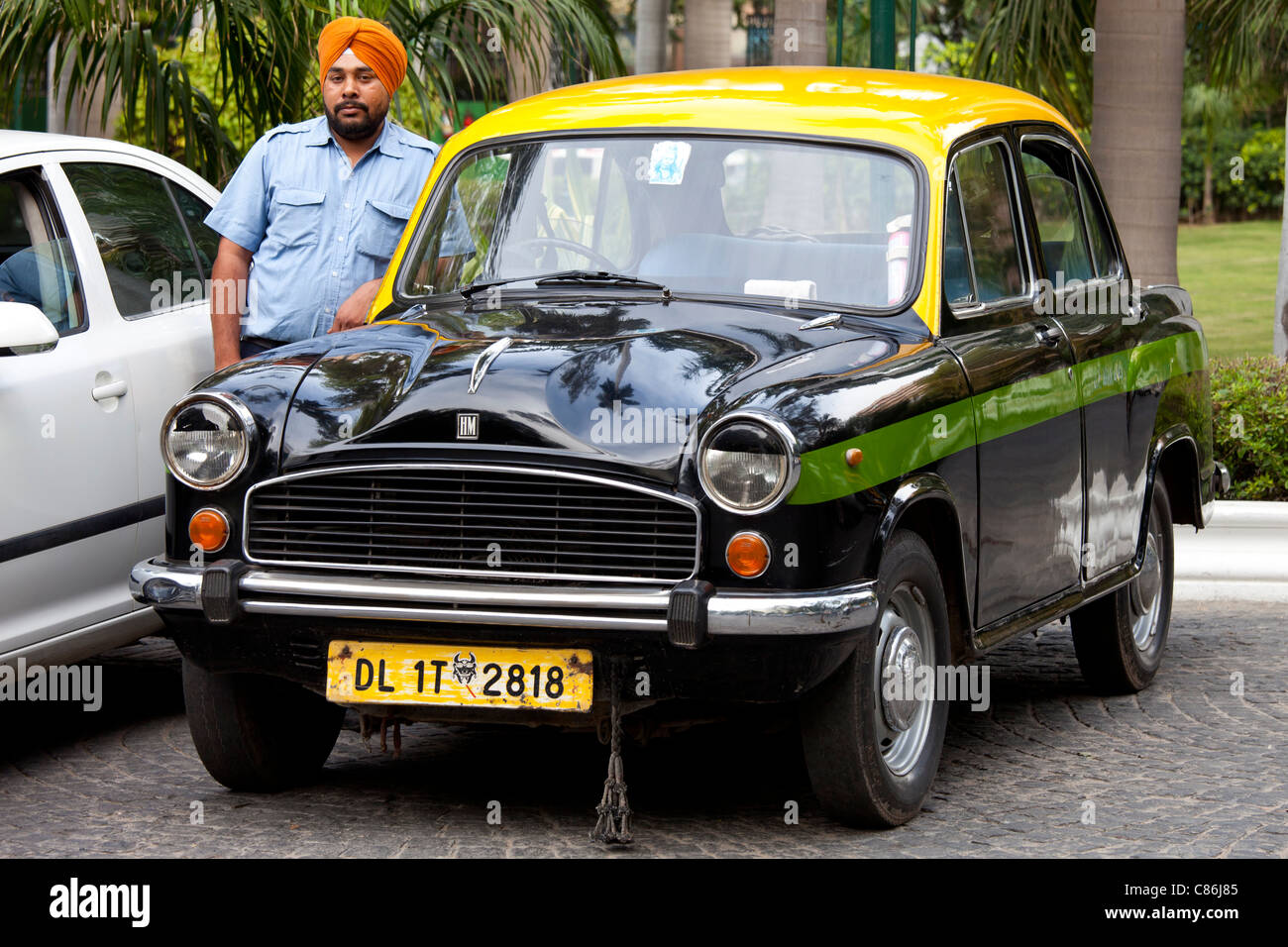 Sikh taxi driver with classic Ambassador taxi at The Imperial Hotel, New Delhi, India Stock Photo
