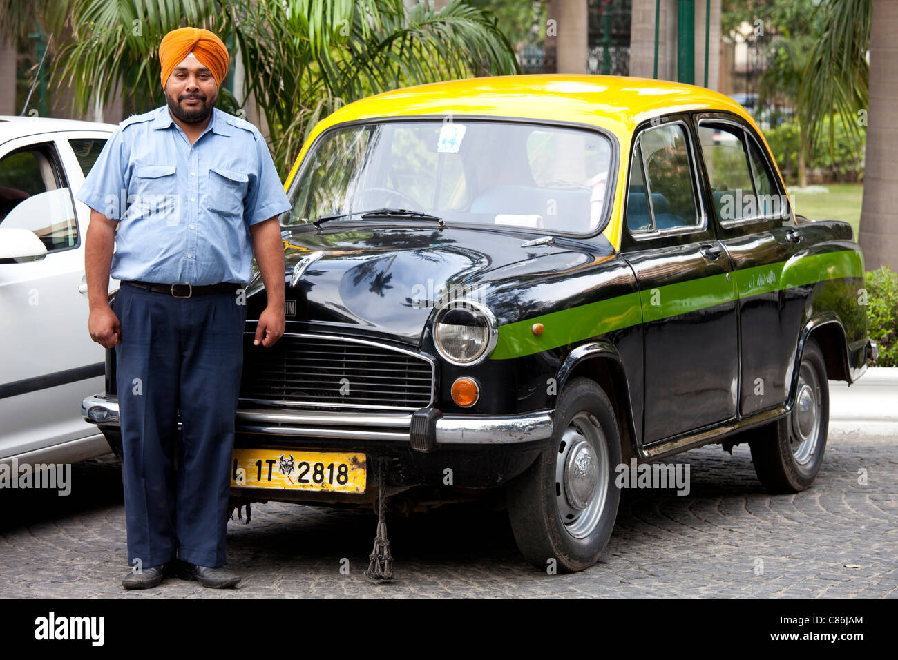 Sikh taxi driver with classic Ambassador taxi at The Imperial Hotel, New Delhi, India Stock Photo