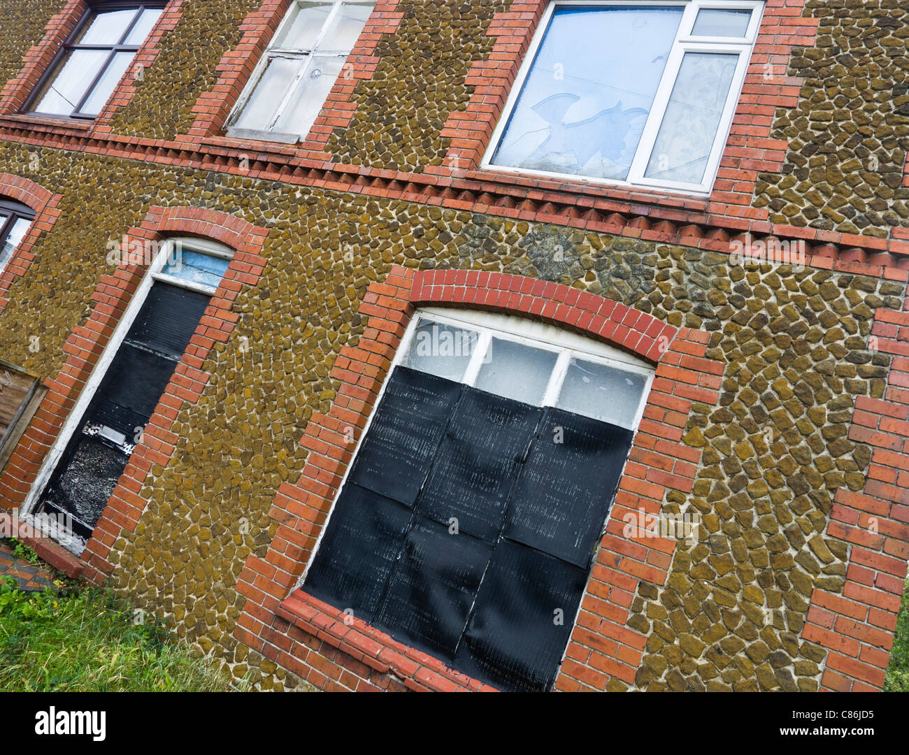 A run down empty property that has been boarded up. Stock Photo
