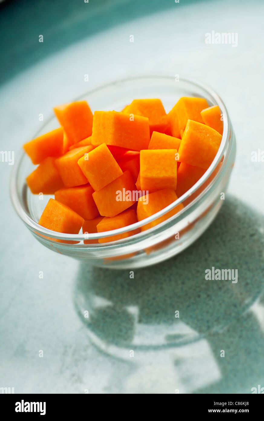 https://c8.alamy.com/comp/C86KJ8/cubed-butternut-squash-ingredient-for-recipe-on-blue-plate-C86KJ8.jpg