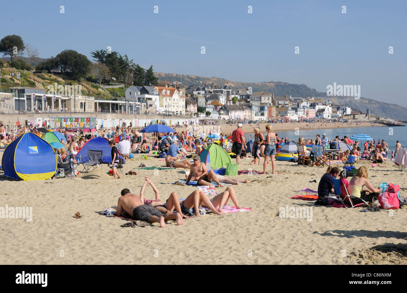Crowded beach scene at Lyme Regis a Dorset England seaside resort on ...
