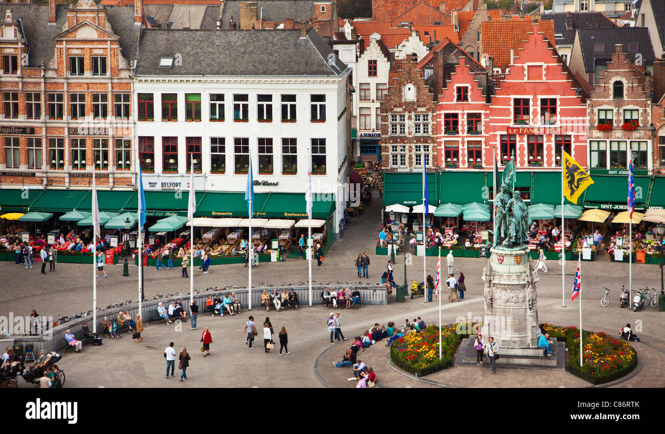View from Belfry of  statue, bars, cafes, restaurants and tourists in Grote Markt or Market Square in Bruges, (Brugge), Belgium Stock Photo