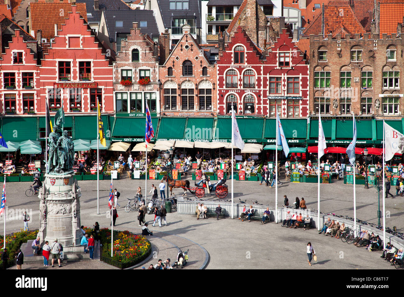 View from Belfry of the statue, bars, restaurants, and tourists in the Grote Markt or Market Square in Bruges, (Brugge), Belgium Stock Photo