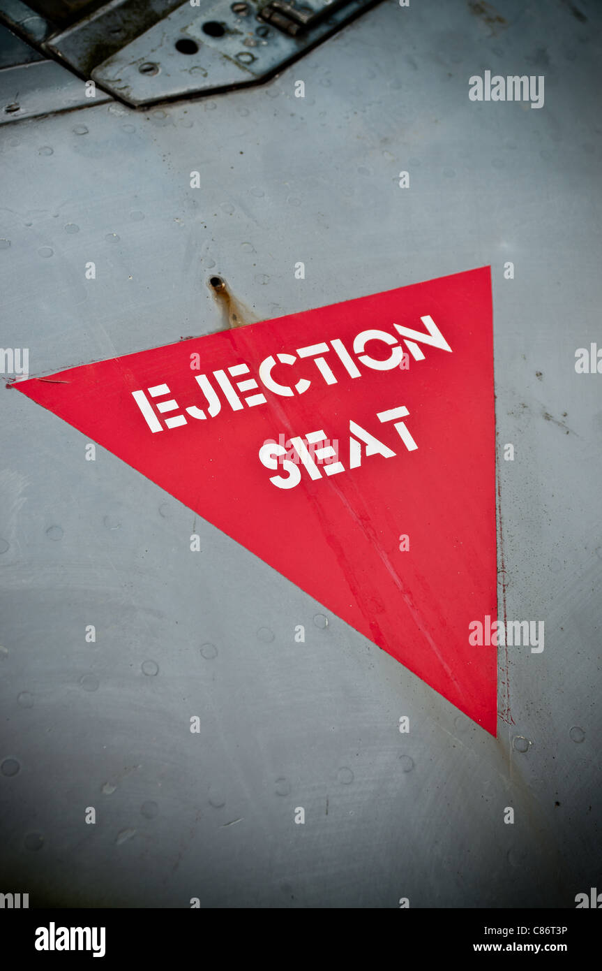 The 'Ejection Seat' warning sign from the fuselage of an old jet fighter Stock Photo