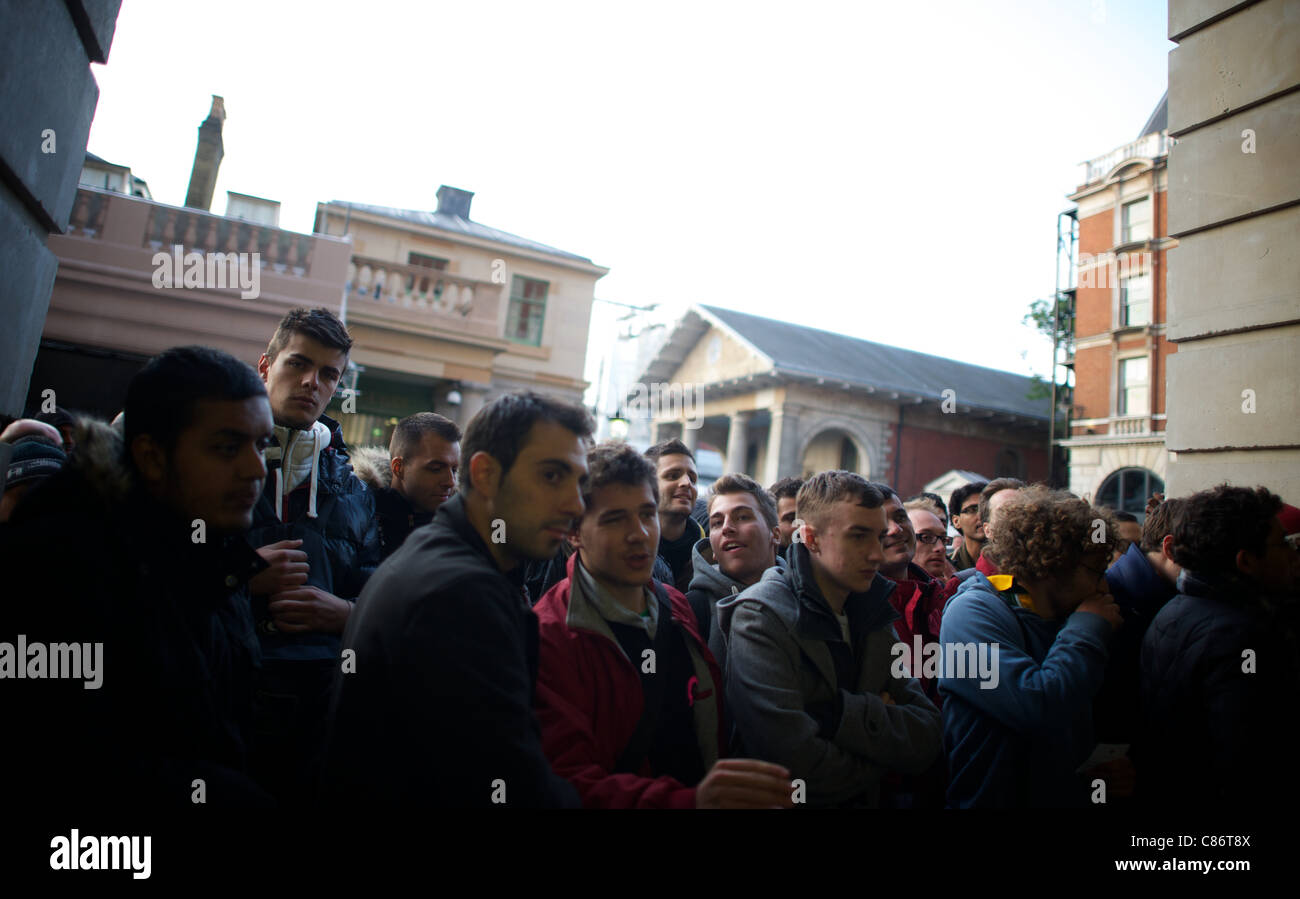 LONDON, UNITED KINGDOM 14 OCTOBER : Pic Shows people queing for the new iphone 4s which goes on sale today at the Covent Garden Branch on October, 14th, 2011 in London, England Stock Photo